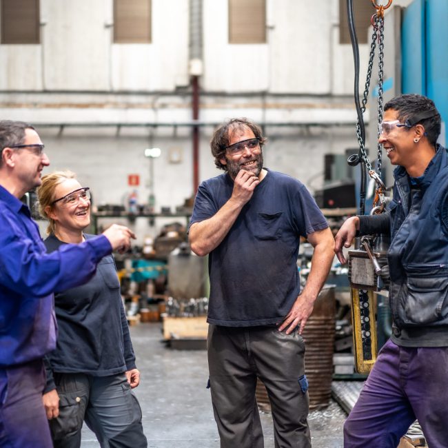 team-of-workers-laughing-at-the-job-of-a-metal-ind-2024-12-09-02-54-26-utc(1)